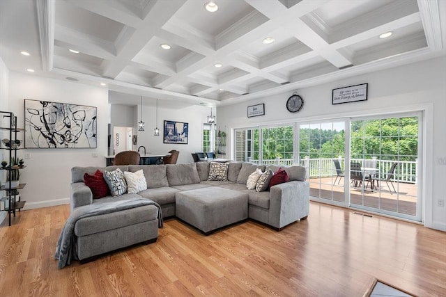 31 Cedar St, North Reading, MA 01864 - living area featuring light wood finished floors, beamed ceiling, healthy amount of natural light, recessed lighting, and coffered ceiling