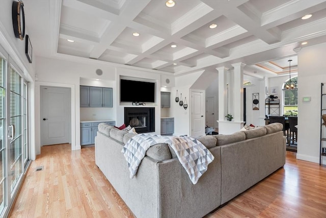 31 Cedar St, North Reading, MA 01864 - living room with a glass covered fireplace, light wood-style floors, beam ceiling, recessed lighting, and crown molding