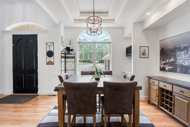 31 Cedar St, North Reading, MA 01864 - dining room with light wood-style flooring, a raised ceiling, ornamental molding, and a chandelier