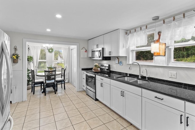 27-1/2 7th Ave, Haverhill, MA 01830 - kitchen with stainless steel appliances, a chandelier, white cabinetry, recessed lighting, and light tile patterned floors