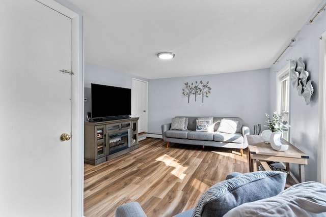 27-1/2 7th Ave, Haverhill, MA 01830 - living area featuring light wood-type flooring and a baseboard heating unit
