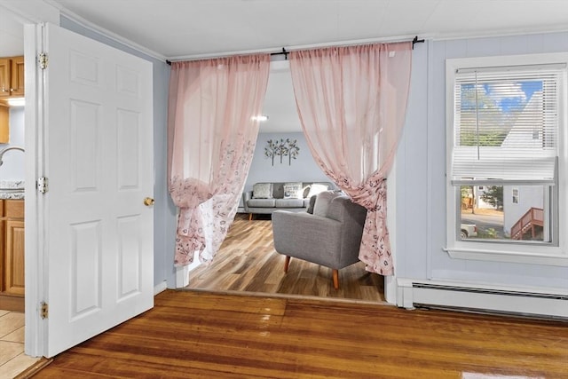 27-1/2 7th Ave, Haverhill, MA 01830 - sitting room with baseboard heating, wood finished floors, and ornamental molding