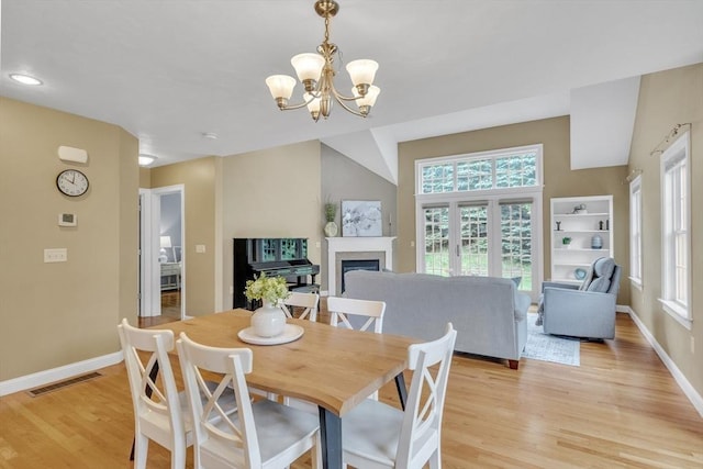 1 Chase Path Unit 1, Acton, MA 01720 - dining room featuring a chandelier, baseboards, a fireplace, and light wood-style floors