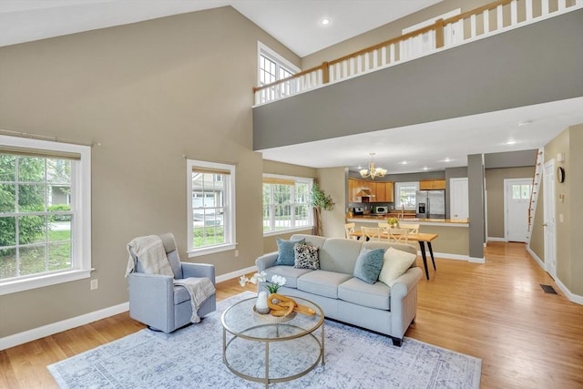 1 Chase Path Unit 1, Acton, MA 01720 - living area featuring a chandelier, light wood-type flooring, baseboards, recessed lighting, and a towering ceiling