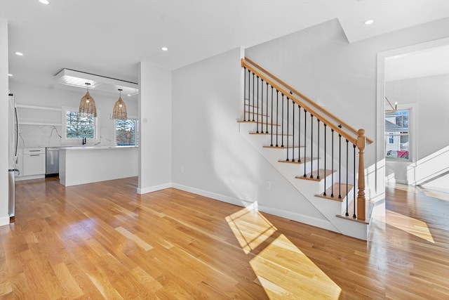 stairs featuring wood-type flooring