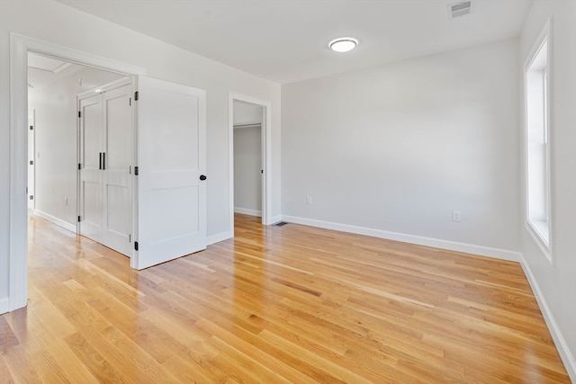 empty room with light hardwood / wood-style floors