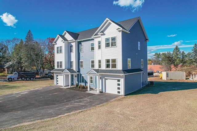 view of front of home featuring a garage and a front lawn