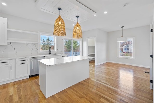 kitchen featuring plenty of natural light, light hardwood / wood-style flooring, and dishwasher