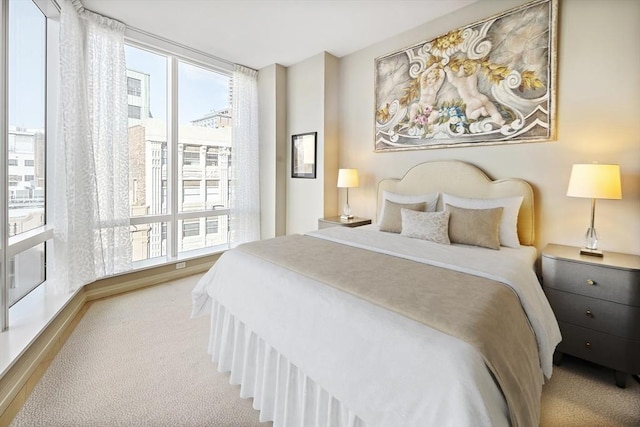 bedroom featuring multiple windows and light colored carpet