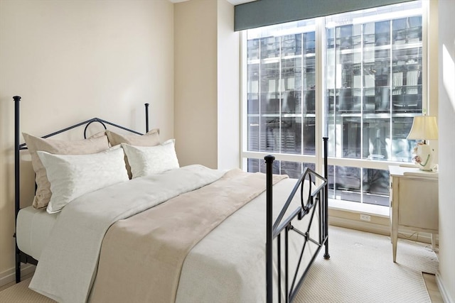 carpeted bedroom featuring multiple windows