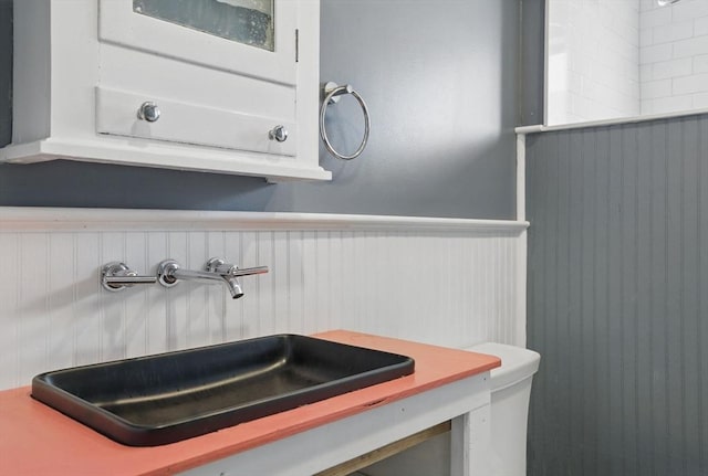 129 Northern Blvd, Newbury, MA 01951 - bathroom with a sink, a wainscoted wall, and toilet