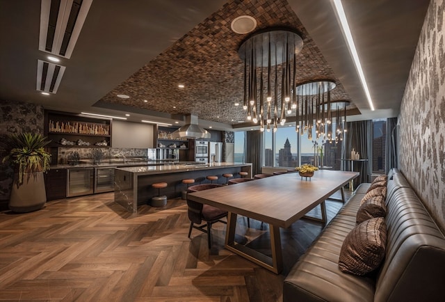 dining area with bar and dark parquet flooring