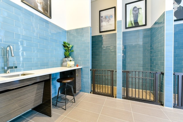 bathroom with tile walls, tile patterned flooring, and vanity