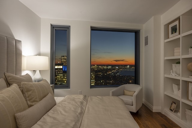 bedroom with dark hardwood / wood-style flooring