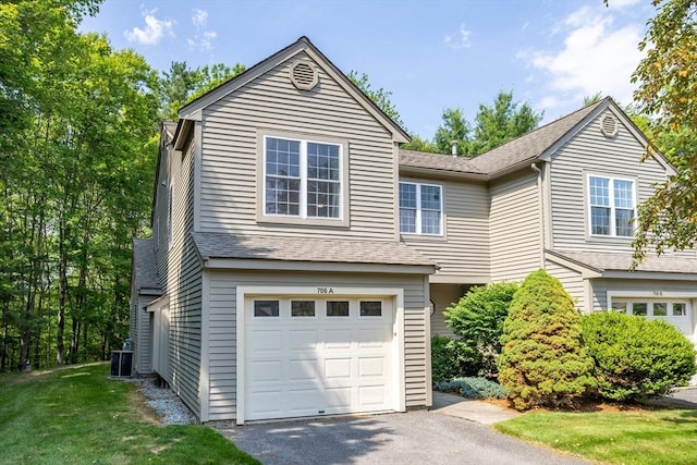 706 Ridgefield Cir Unit A, Clinton, MA 01510 - view of front facade featuring a garage, driveway, and roof with shingles