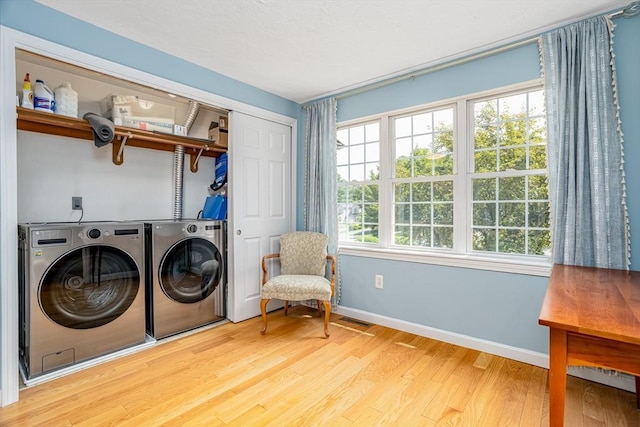 706 Ridgefield Cir Unit A, Clinton, MA 01510 - laundry area with washing machine and dryer, light wood-style floors, and healthy amount of natural light