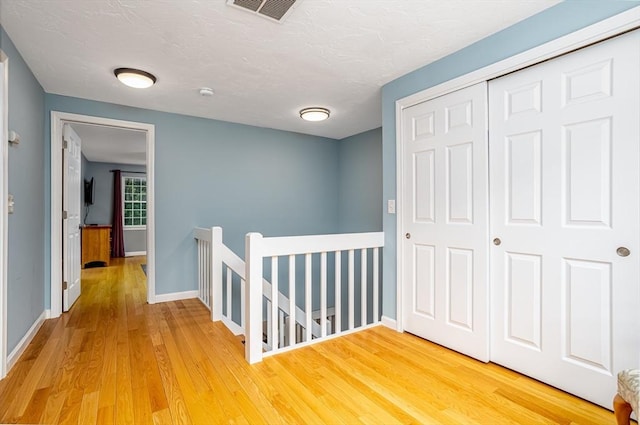 706 Ridgefield Cir Unit A, Clinton, MA 01510 - hallway featuring an upstairs landing and light wood-style floors