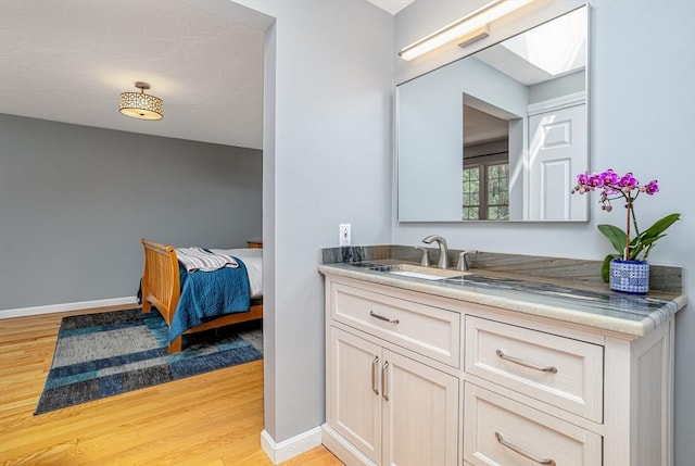 706 Ridgefield Cir Unit A, Clinton, MA 01510 - bathroom featuring wood finished floors, vanity, and a skylight