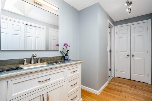 706 Ridgefield Cir Unit A, Clinton, MA 01510 - bathroom featuring vanity, wood finished floors, and a closet
