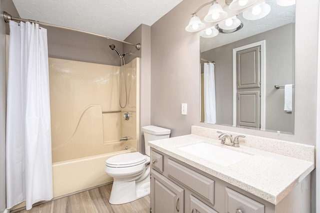 706 Ridgefield Cir Unit A, Clinton, MA 01510 - full bathroom featuring vanity, wood finished floors, shower / tub combo, and a textured ceiling