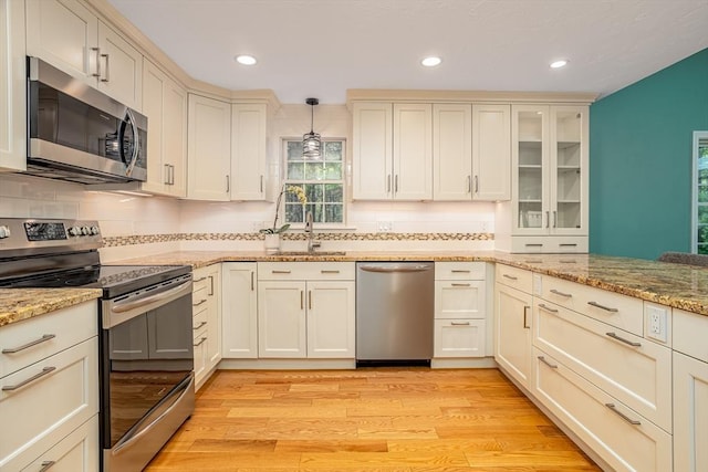 706 Ridgefield Cir Unit A, Clinton, MA 01510 - kitchen featuring appliances with stainless steel finishes, backsplash, recessed lighting, and light wood finished floors