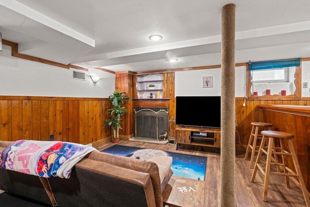 143 Morton St, Winthrop, MA 02152 - living room with wood walls, wainscoting, wood finished floors, a fireplace with raised hearth, and a bar