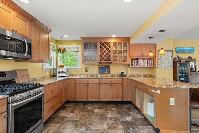 143 Morton St, Winthrop, MA 02152 - kitchen with stainless steel appliances, a peninsula, brown cabinetry, glass insert cabinets, and light stone counters