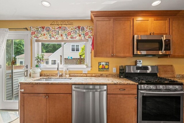 143 Morton St, Winthrop, MA 02152 - kitchen with stainless steel appliances, a sink, light stone countertops, brown cabinetry, and recessed lighting