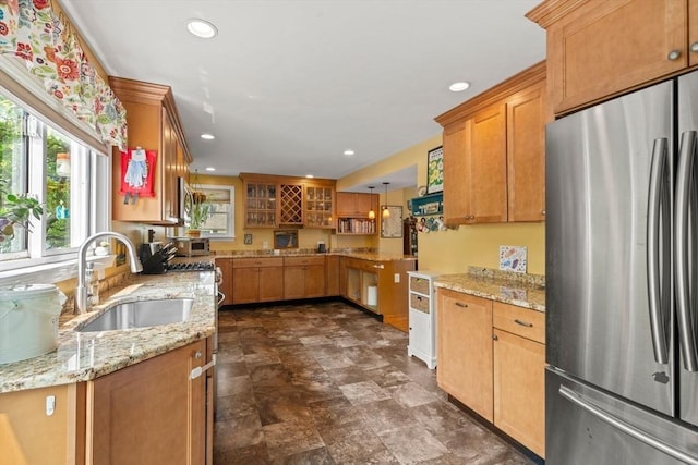 143 Morton St, Winthrop, MA 02152 - kitchen featuring stainless steel appliances, a sink, recessed lighting, light stone counters, and glass insert cabinets