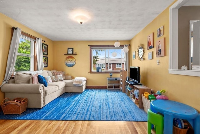 143 Morton St, Winthrop, MA 02152 - living area with wood finished floors, a textured ceiling, and baseboards
