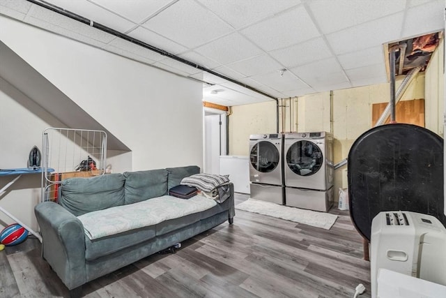 laundry area with independent washer and dryer, laundry area, heating fuel, and wood finished floors
