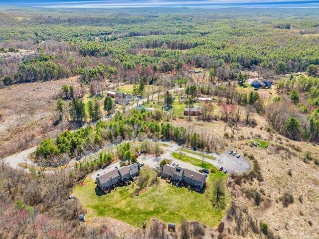 drone / aerial view featuring a wooded view