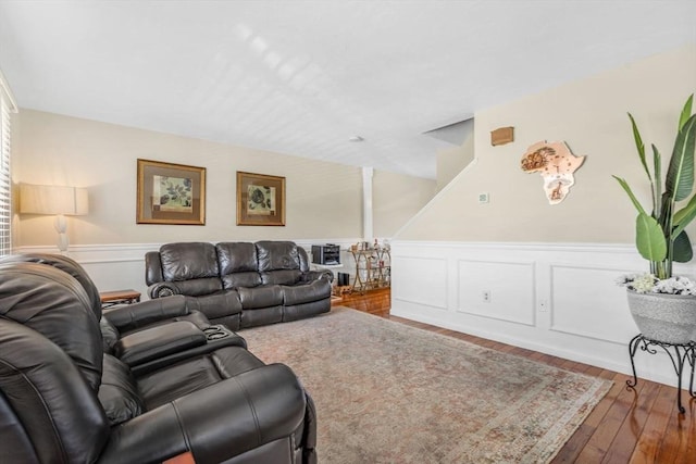 living room with a wainscoted wall and wood-type flooring