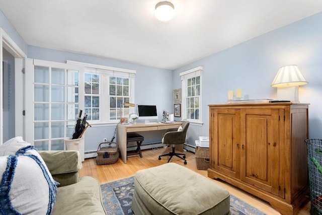 office featuring a baseboard heating unit and light hardwood / wood-style flooring