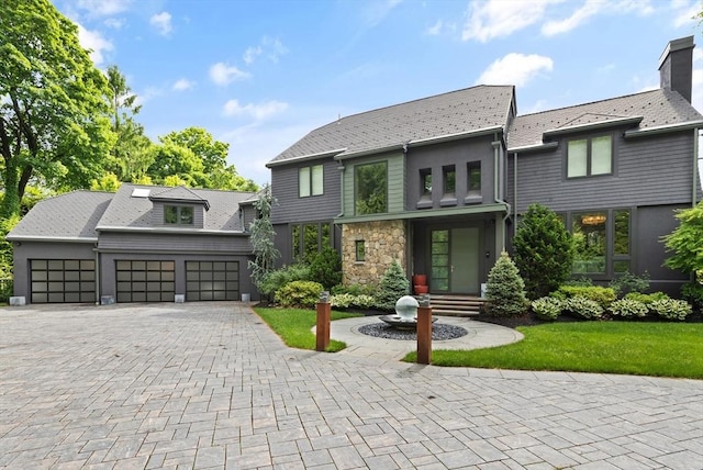 view of front of home featuring a garage and a front lawn