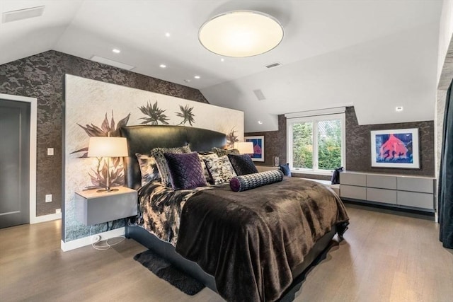 bedroom featuring lofted ceiling and hardwood / wood-style flooring