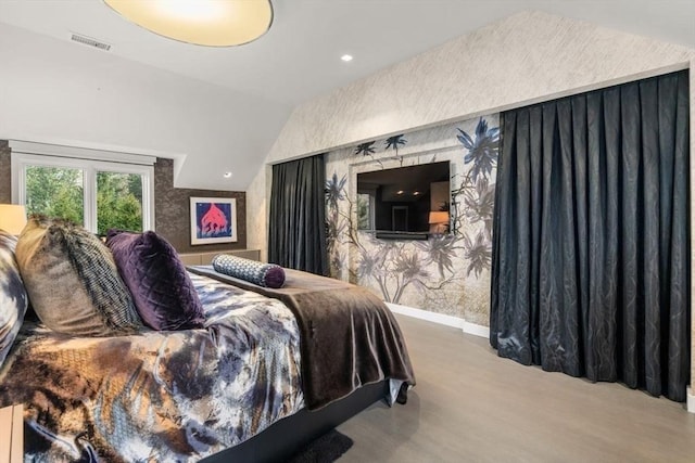 bedroom with hardwood / wood-style flooring and vaulted ceiling