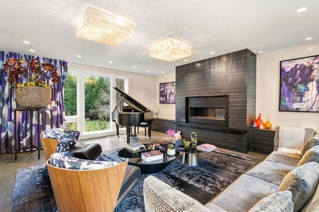 living room with a fireplace, hardwood / wood-style flooring, and a chandelier