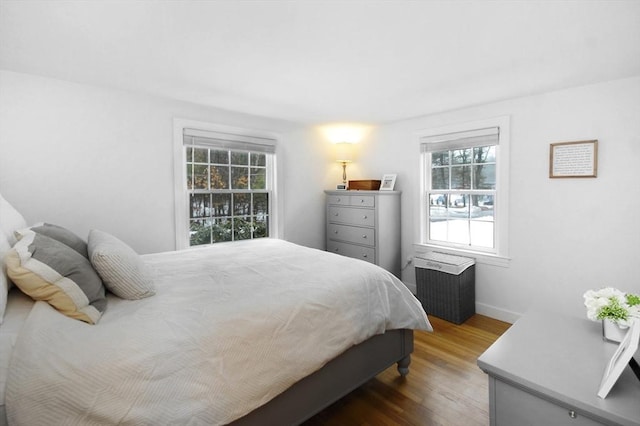 bedroom with baseboards and wood finished floors