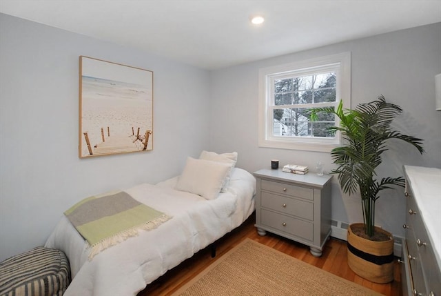 bedroom featuring wood finished floors and recessed lighting