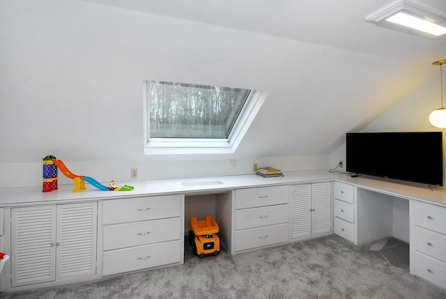 office area with lofted ceiling, built in study area, and light colored carpet