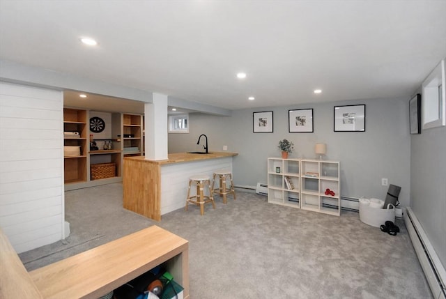 interior space featuring carpet, a baseboard heating unit, a sink, and recessed lighting