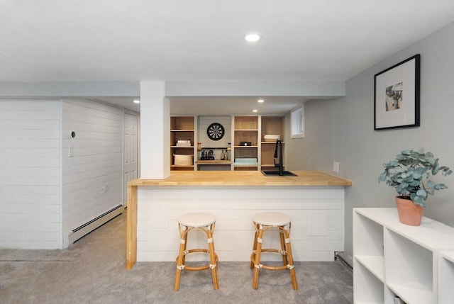 interior space featuring recessed lighting, a baseboard heating unit, a sink, and carpet flooring