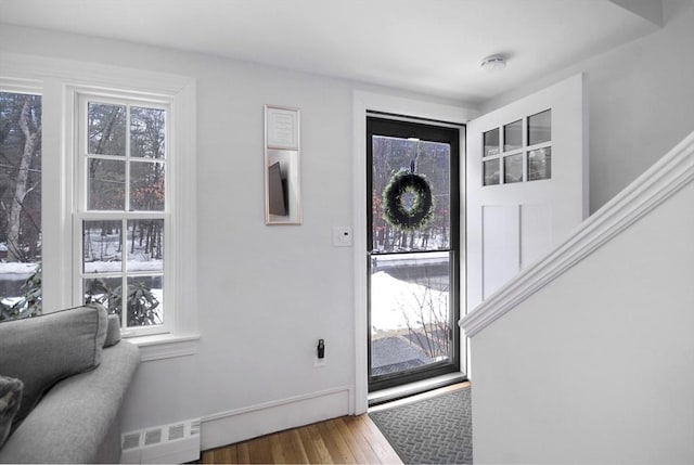 entryway with stairway, visible vents, and wood finished floors