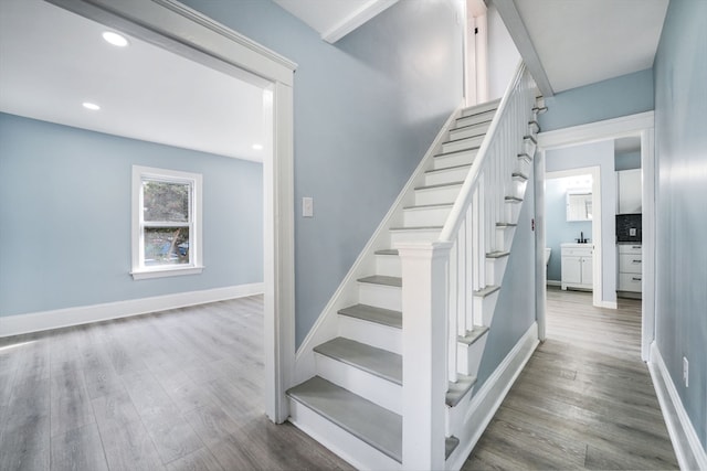 stairway featuring hardwood / wood-style flooring