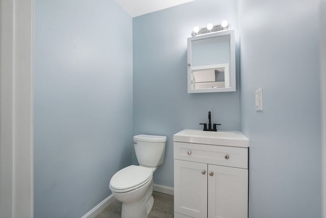 bathroom with vanity, hardwood / wood-style floors, and toilet