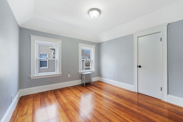 interior space with hardwood / wood-style flooring and radiator