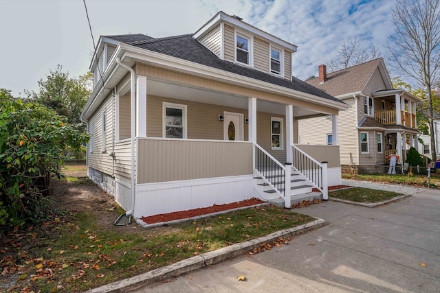 view of front of house with a balcony and covered porch