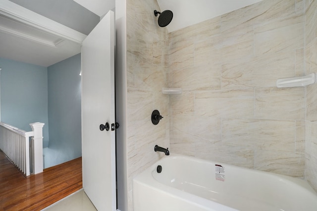 bathroom with tiled shower / bath combo and hardwood / wood-style flooring