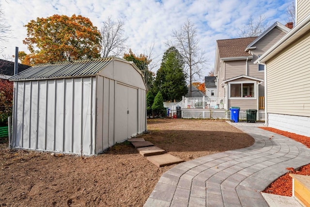 view of yard featuring a deck and a shed